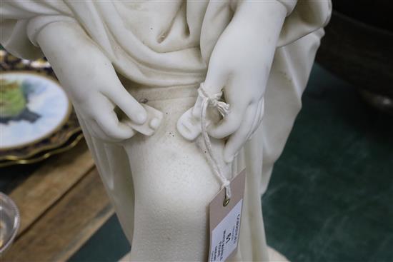 A Victorian style carved white marble figure of a woman pulling on her stocking, H.31in.